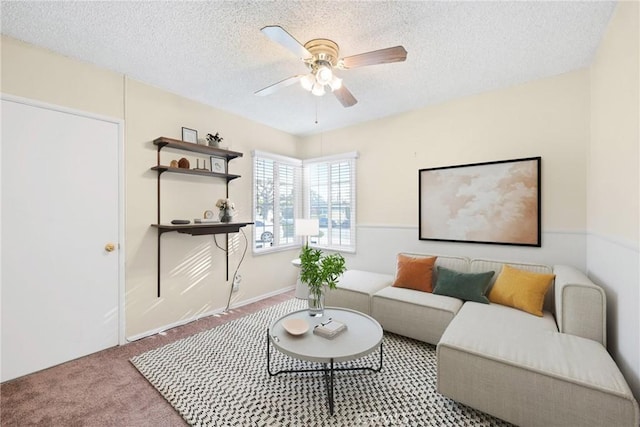 living room with light carpet, ceiling fan, and a textured ceiling