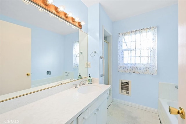 bathroom featuring heating unit and vanity