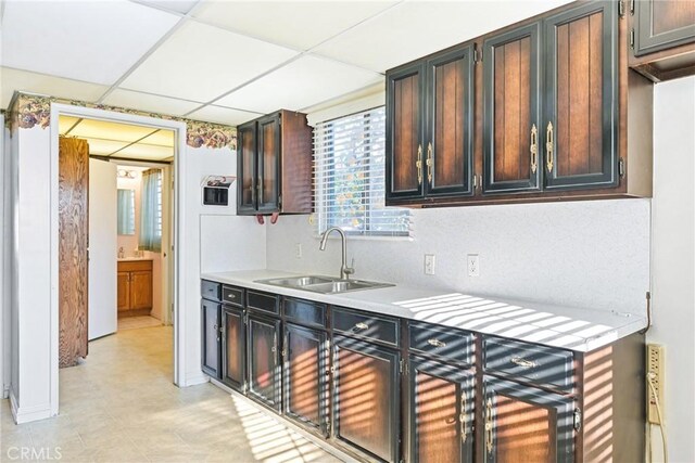 kitchen featuring sink and a drop ceiling