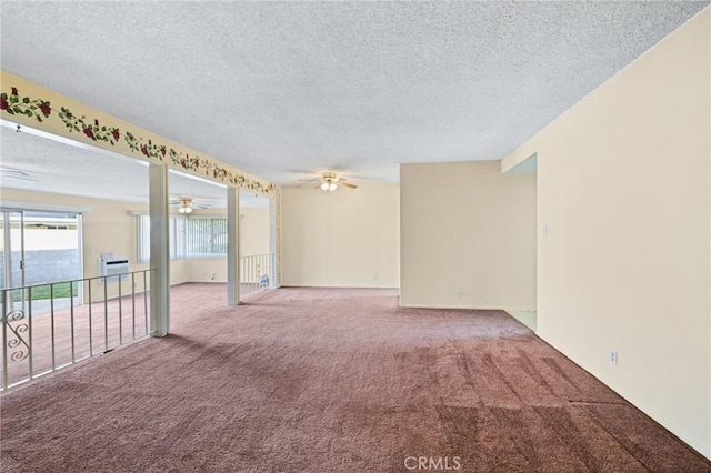 empty room with carpet, a textured ceiling, and ceiling fan