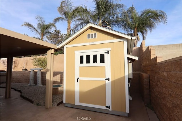 view of shed featuring a fenced backyard