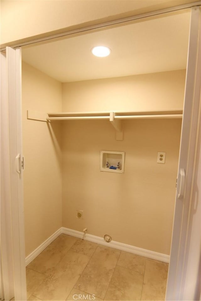 clothes washing area with baseboards, gas dryer hookup, hookup for a washing machine, and hookup for an electric dryer