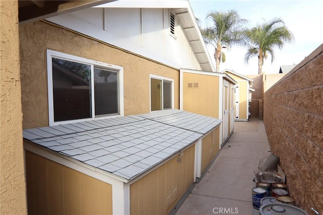 view of side of home featuring fence