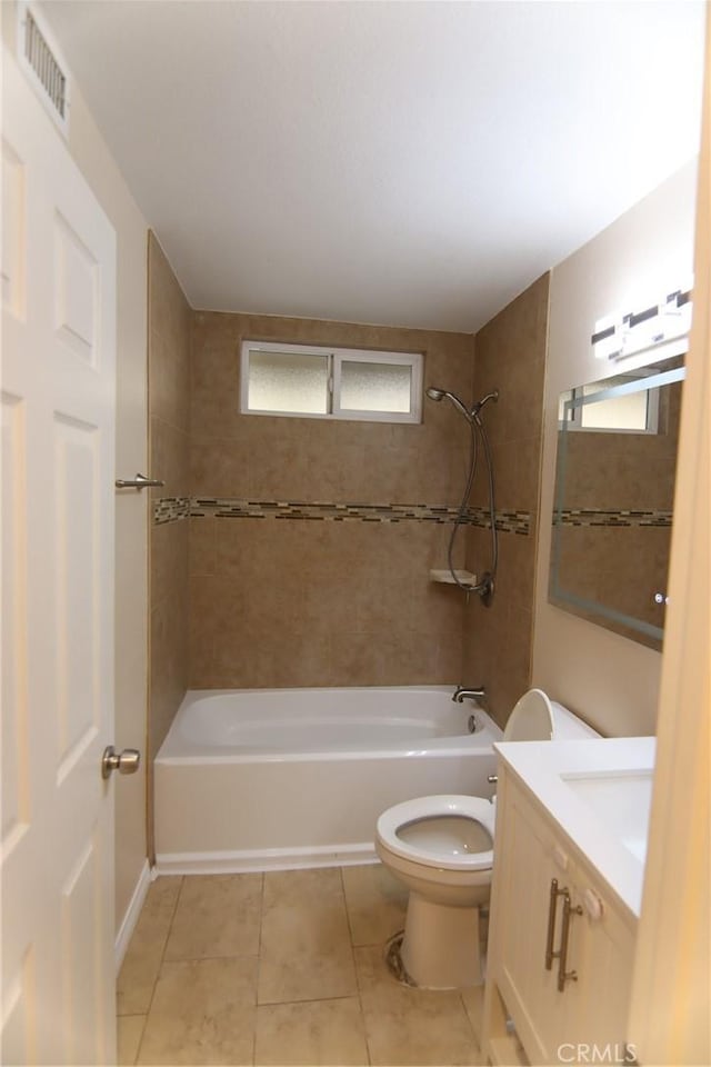 bathroom featuring tile patterned flooring, toilet, vanity, visible vents, and shower / washtub combination