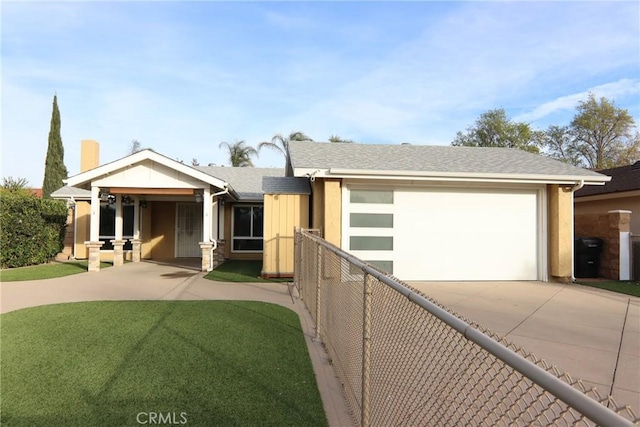 view of front of house featuring a garage and a front lawn