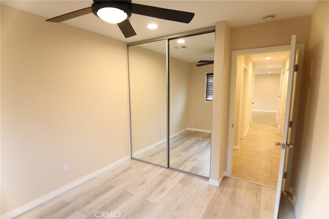 unfurnished bedroom featuring recessed lighting, a closet, ceiling fan, light wood-type flooring, and baseboards