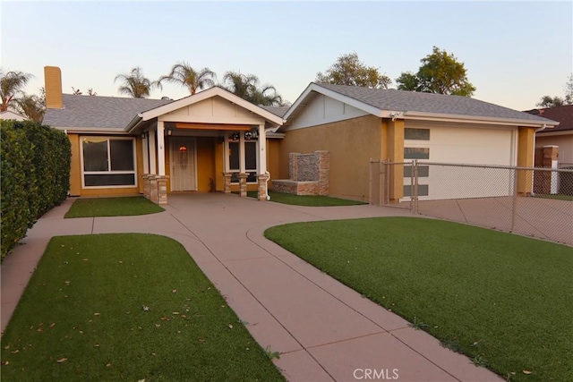 ranch-style house with a garage, concrete driveway, fence, a yard, and stucco siding