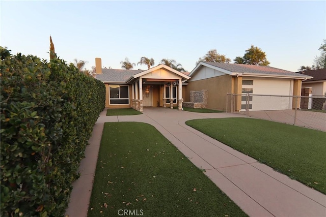 view of front of home featuring driveway, a front yard, fence, and stucco siding