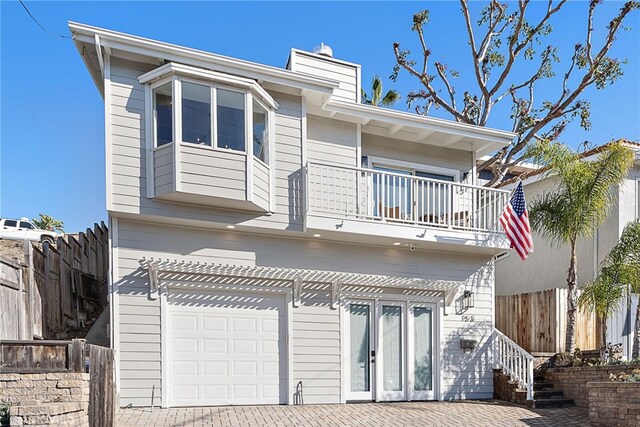 back of property with a pergola and a balcony