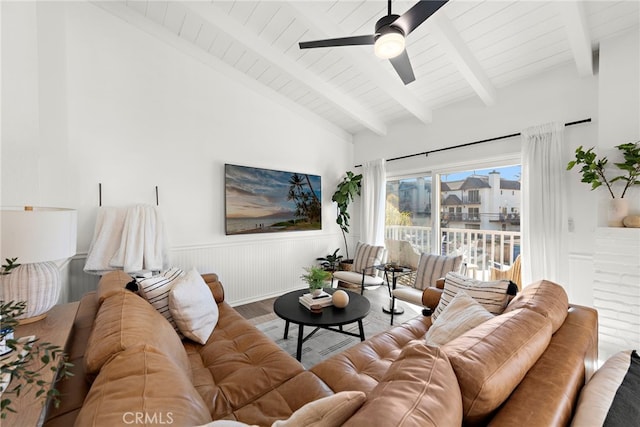 living room featuring hardwood / wood-style floors, vaulted ceiling with beams, and ceiling fan