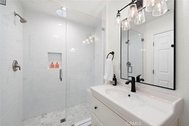 bathroom with vanity and a shower with shower door