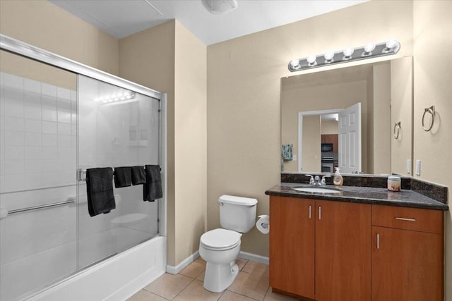 full bathroom featuring tile patterned flooring, vanity, toilet, and combined bath / shower with glass door