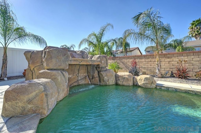 view of swimming pool with pool water feature