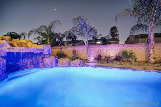 view of pool at dusk