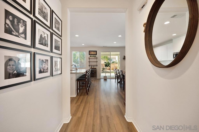 corridor featuring light hardwood / wood-style floors