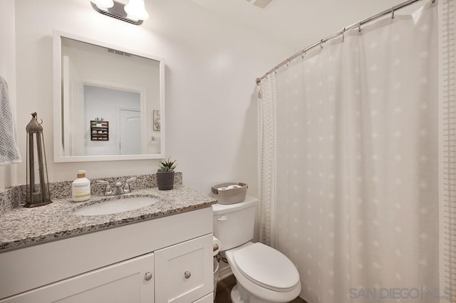 bathroom with toilet and vanity