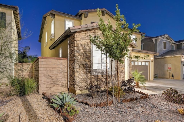 mediterranean / spanish-style house with a garage