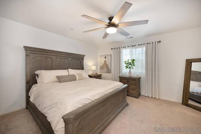 bedroom with ceiling fan and light carpet