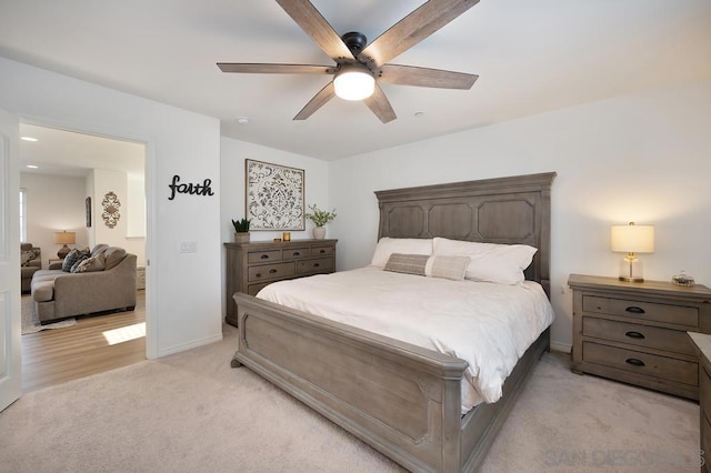 bedroom featuring light carpet and ceiling fan