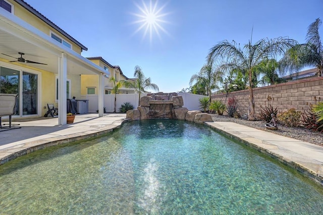 view of pool featuring pool water feature, a patio area, and ceiling fan