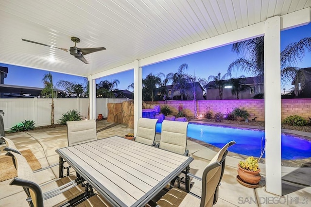 view of patio / terrace featuring ceiling fan and a fenced in pool