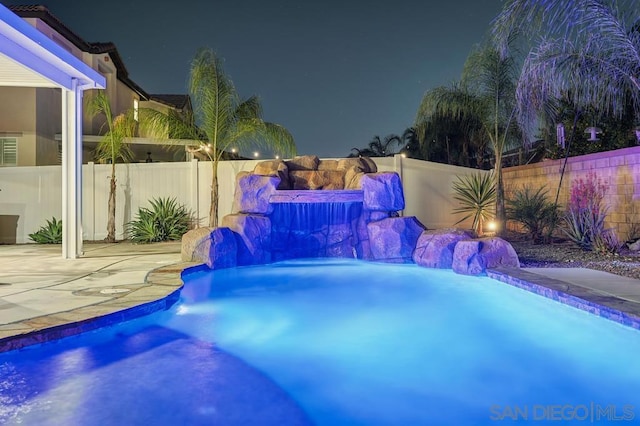 view of pool at night