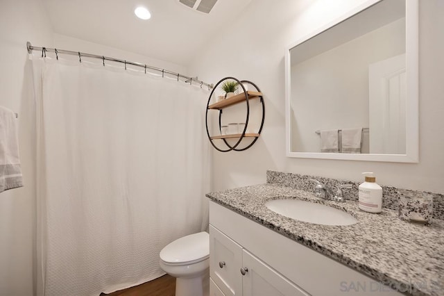 bathroom featuring hardwood / wood-style floors, vanity, and toilet