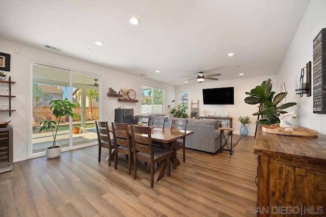 dining area with ceiling fan and wood-type flooring