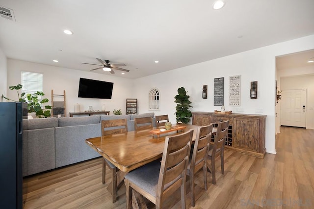 dining space featuring light wood-type flooring and ceiling fan