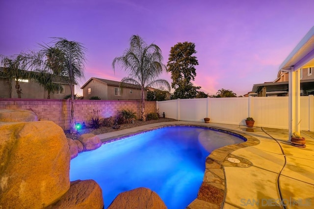 view of pool at dusk