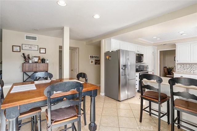 dining space featuring light tile patterned floors