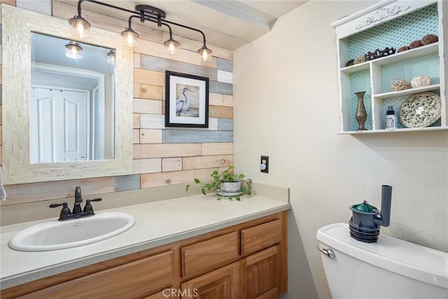 bathroom featuring toilet and vanity