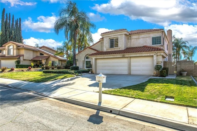 mediterranean / spanish-style house with a front yard and a garage