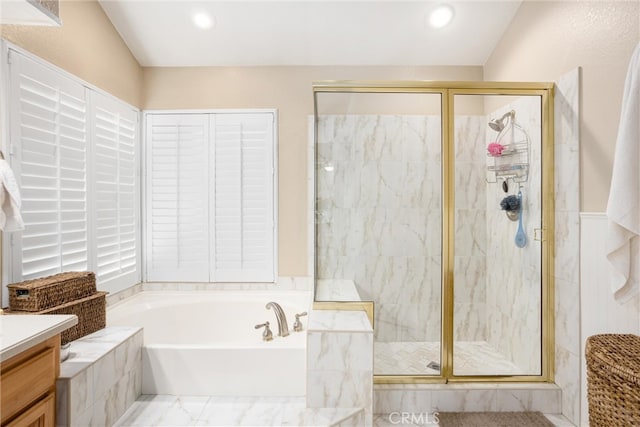 bathroom with vanity and separate shower and tub