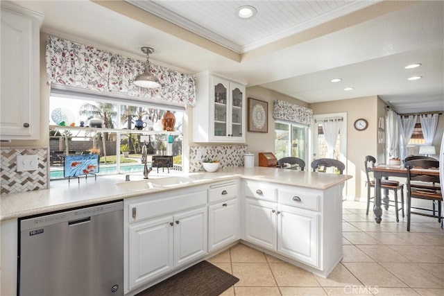 kitchen with decorative backsplash, dishwasher, pendant lighting, white cabinets, and sink