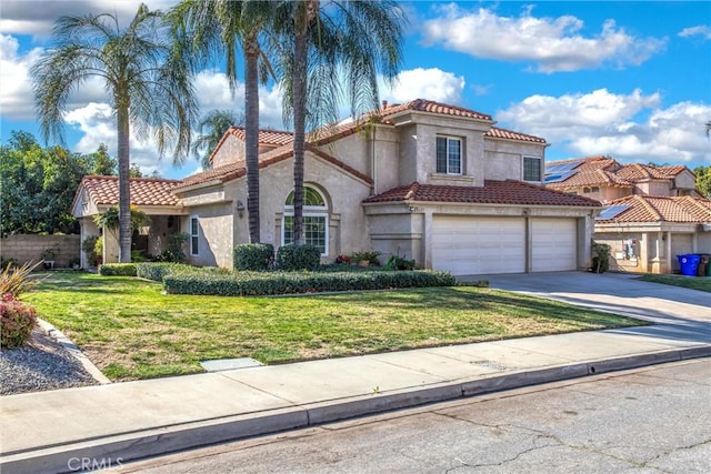 mediterranean / spanish house with a garage and a front lawn