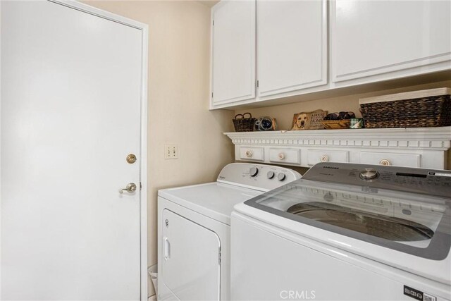 laundry area featuring cabinets and separate washer and dryer