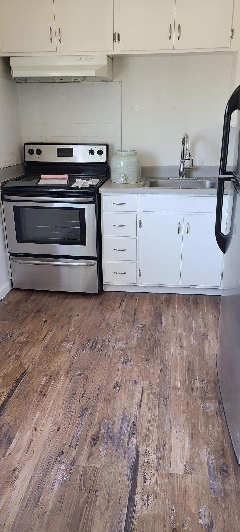 kitchen with white cabinets, sink, and stainless steel electric range