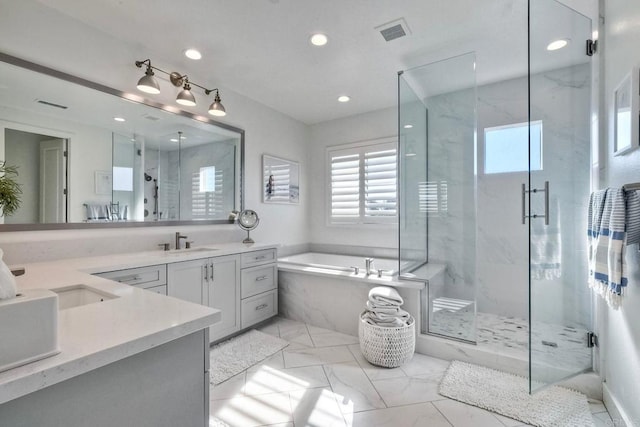 bathroom featuring separate shower and tub and vanity