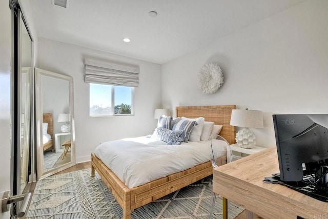 bedroom with hardwood / wood-style floors