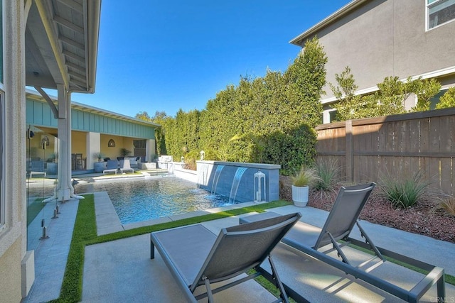 view of pool featuring pool water feature and a patio