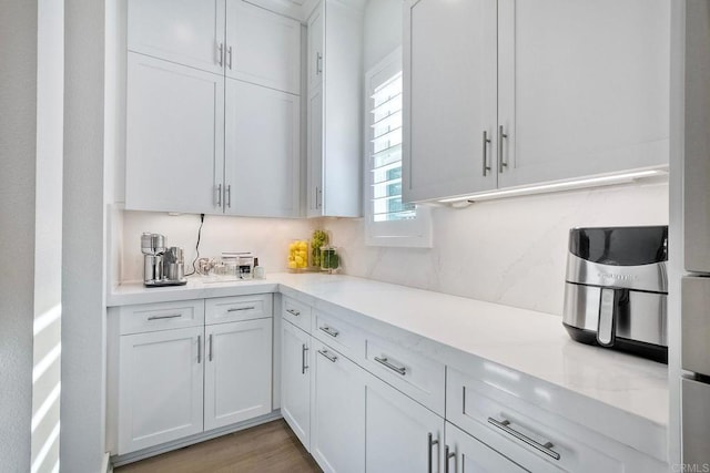 kitchen featuring white cabinets and light hardwood / wood-style flooring