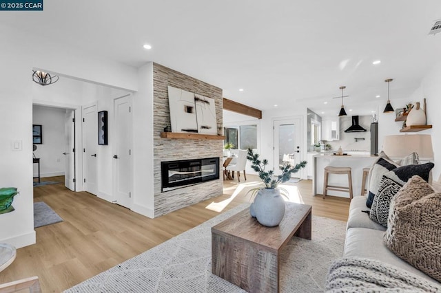 living room with a fireplace and light hardwood / wood-style flooring