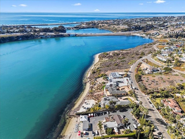 birds eye view of property featuring a water view and a beach view