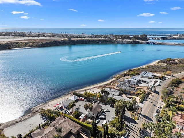 birds eye view of property featuring a water view and a beach view