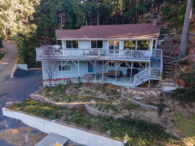 view of front of home with a patio area and a wooden deck