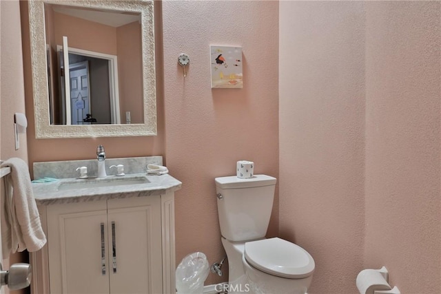 bathroom featuring toilet and vanity