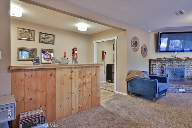 bar with a brick fireplace and carpet