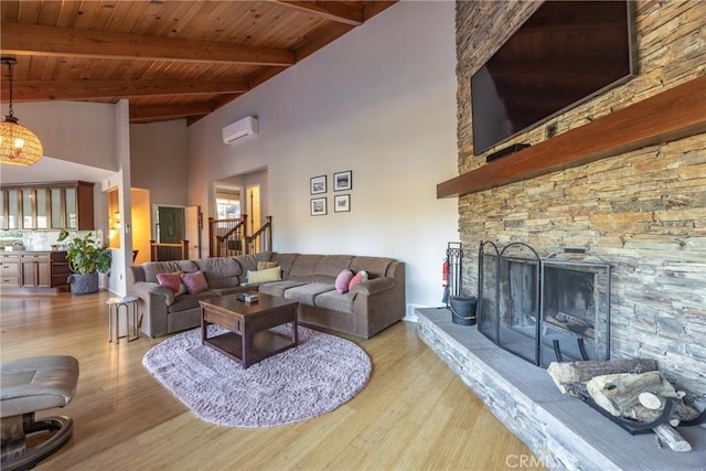 living room featuring light wood-type flooring, a wall unit AC, a stone fireplace, and wooden ceiling