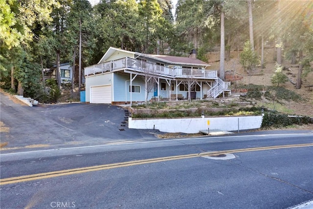 view of property featuring a deck and a garage